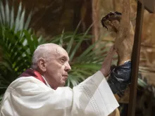 Pope Francis adores the crucifix during the Good Friday liturgy at St. Peter's Basilica April 2, 2021.
